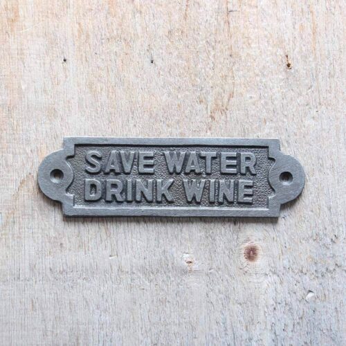 cast iron sign save water drink wine